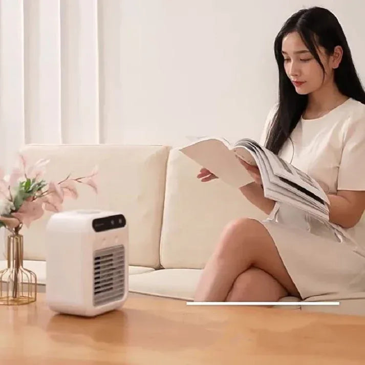 Woman reading a magazine next to a LivinH Mini air cooler.